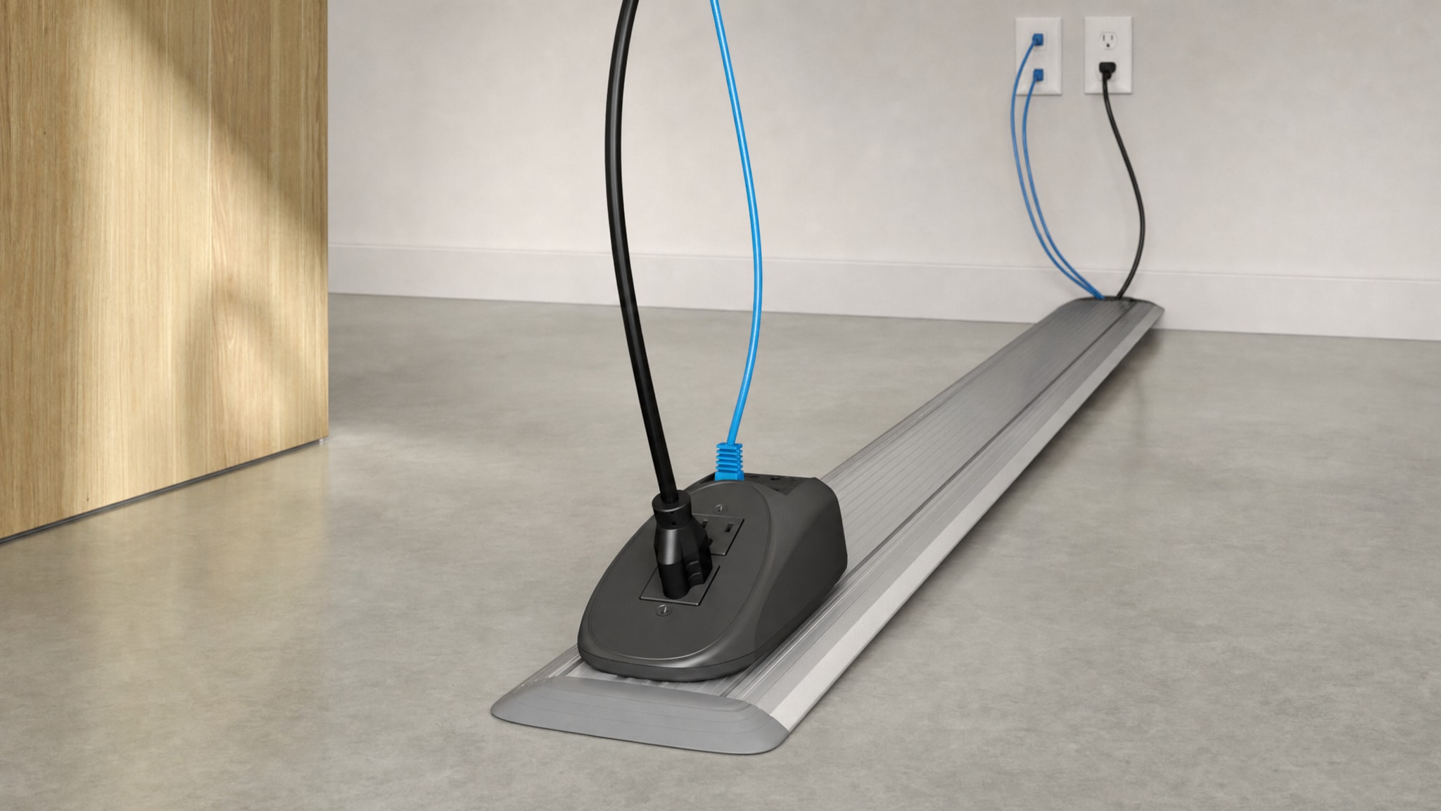 Low-profile floor cable raceway leading to a power and data outlet box.