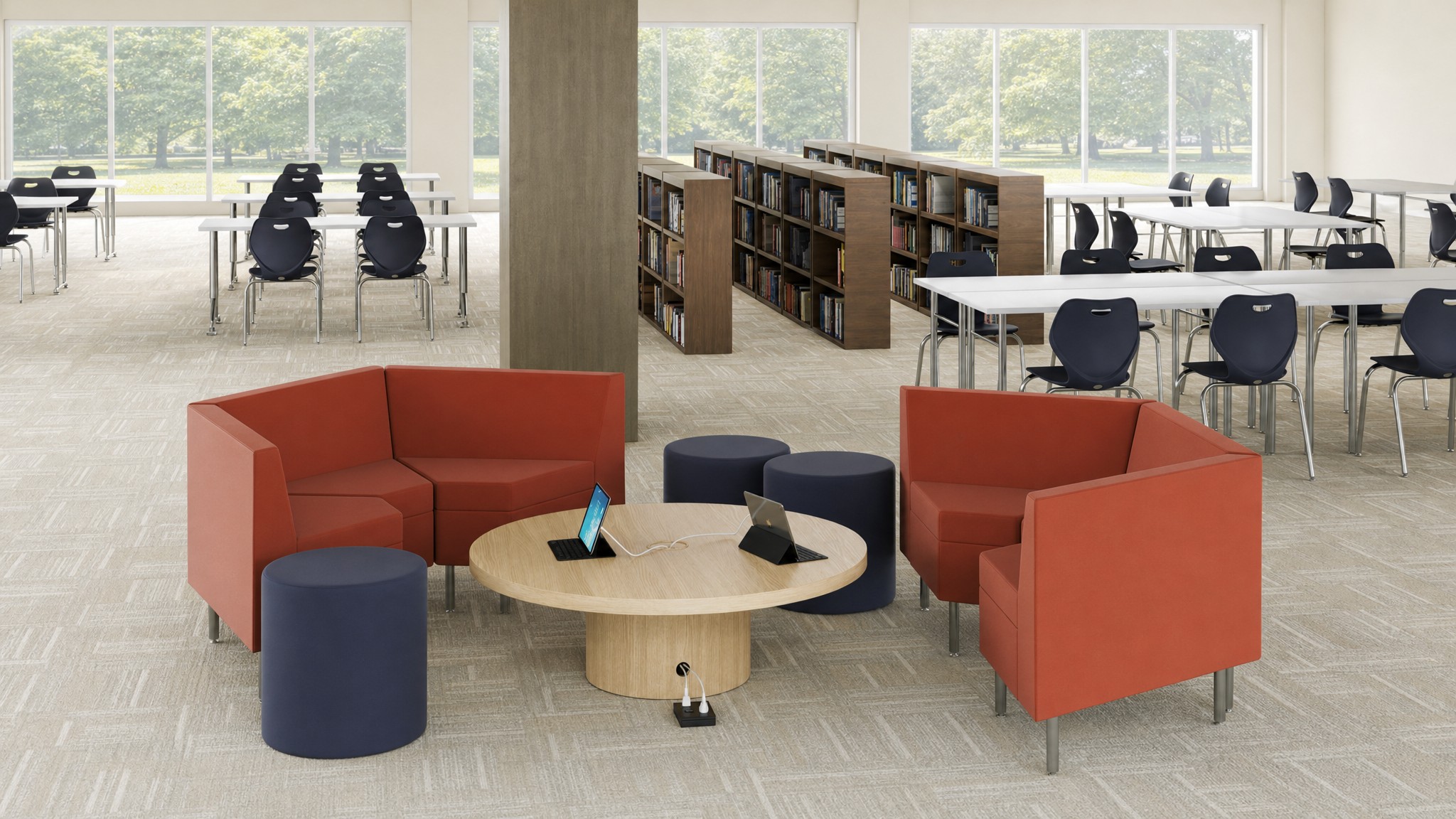 Carpeted room with floor cable raceway leading to round table and orange seating area.