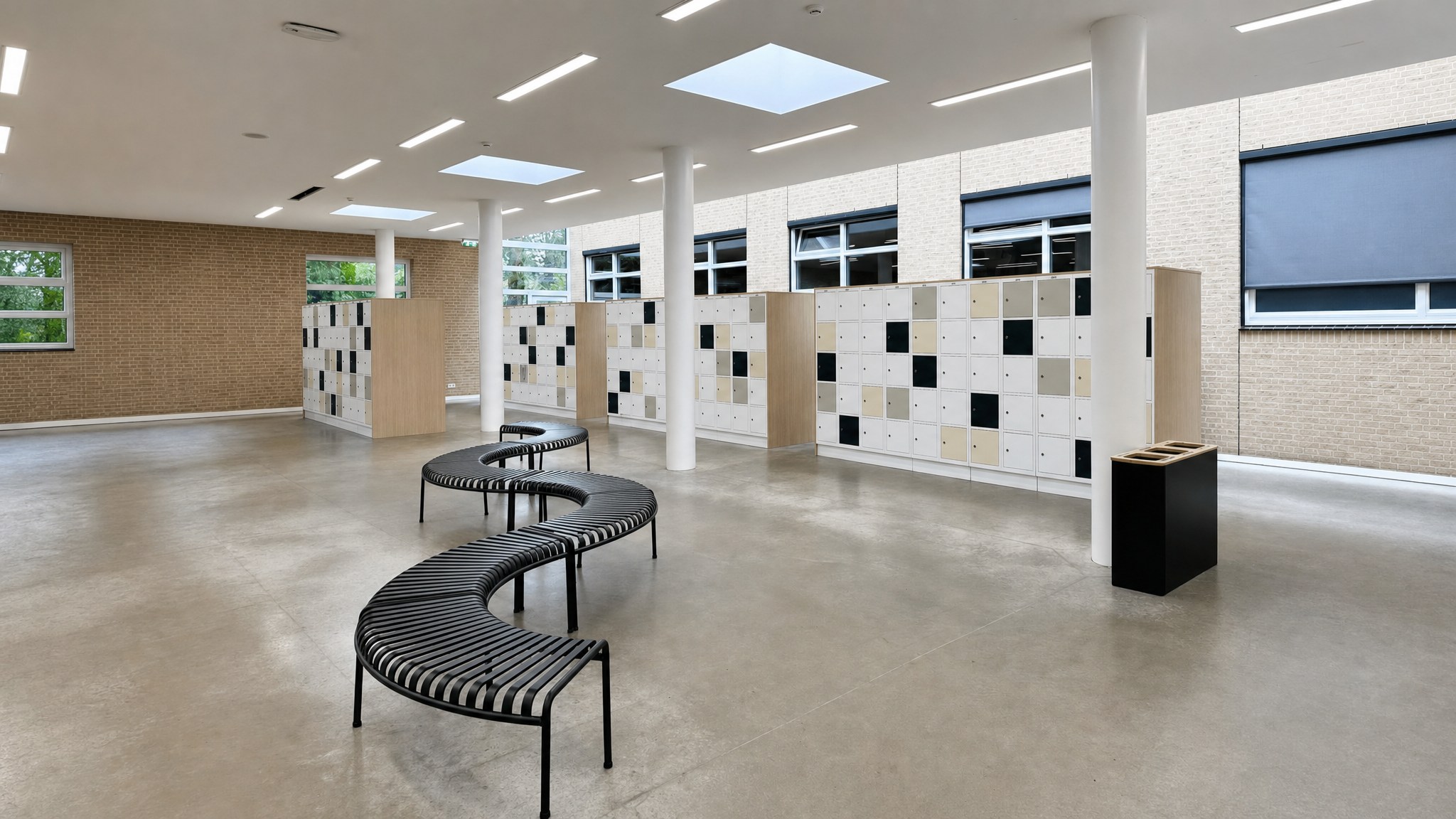Modular locker walls with white and black doors in a spacious room with benches.