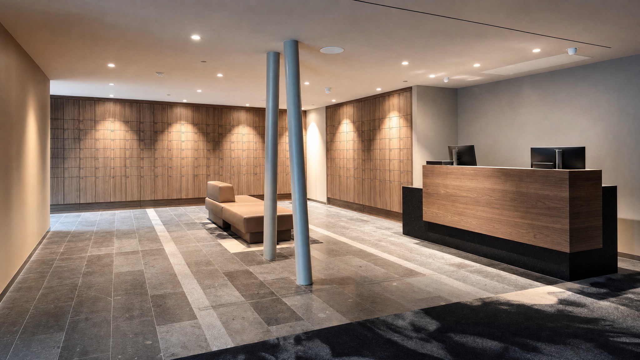 Wood-finish locker walls with a bench and a wood front desk in a modern room.