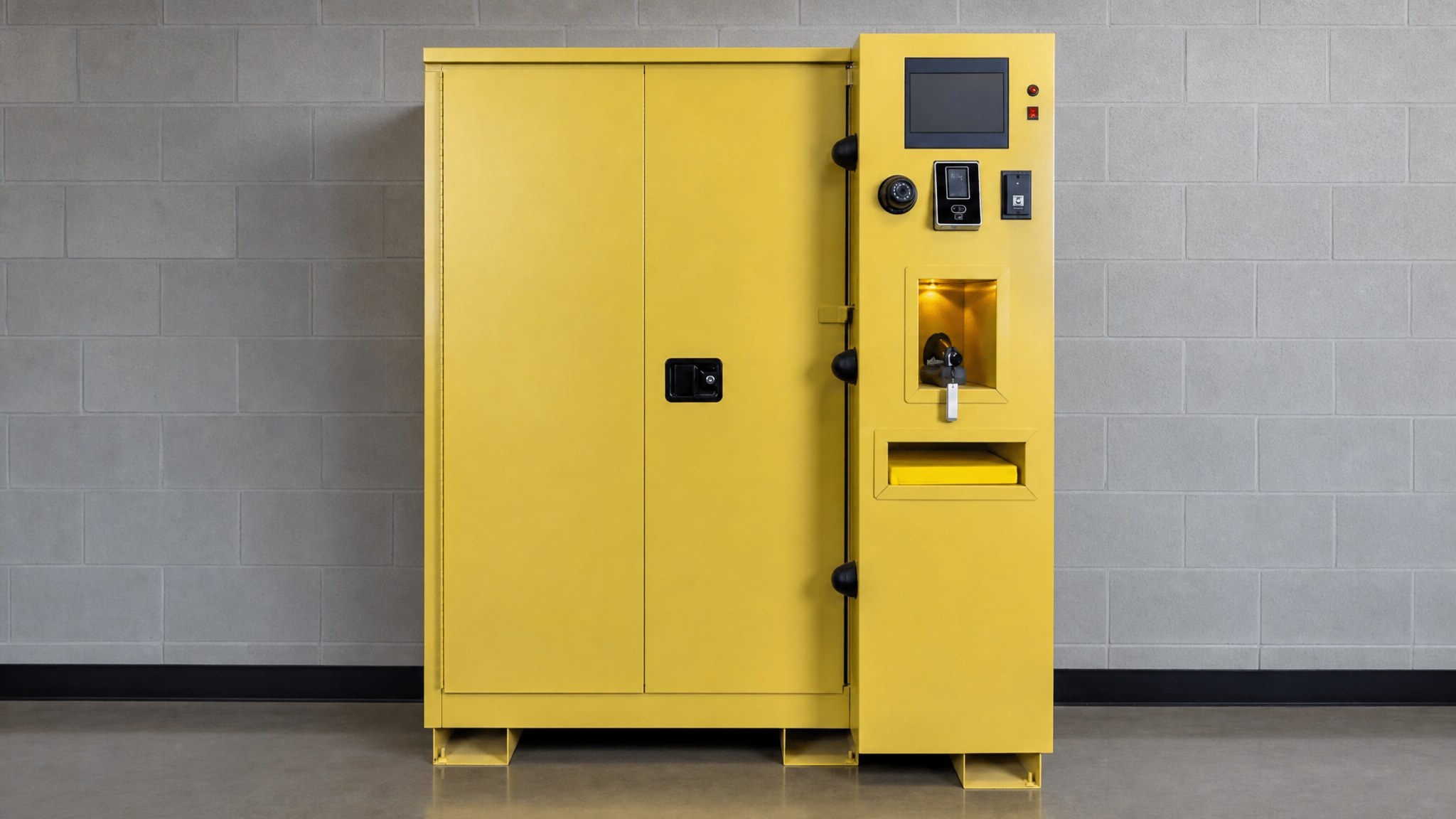 Yellow storage cabinet with access control panel and display against a gray block wall.